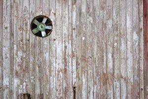 old fan in wooden wall